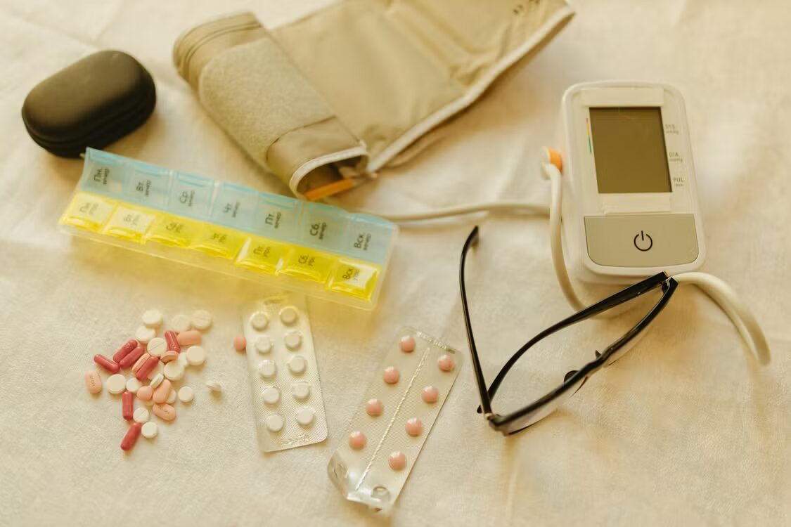An image of a blood pressure monitor and medicines