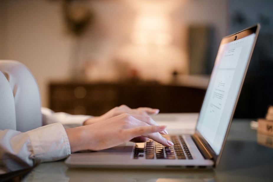 Individual completing forms online as part of a prescription assistance enrollment or healthcare benefits application.