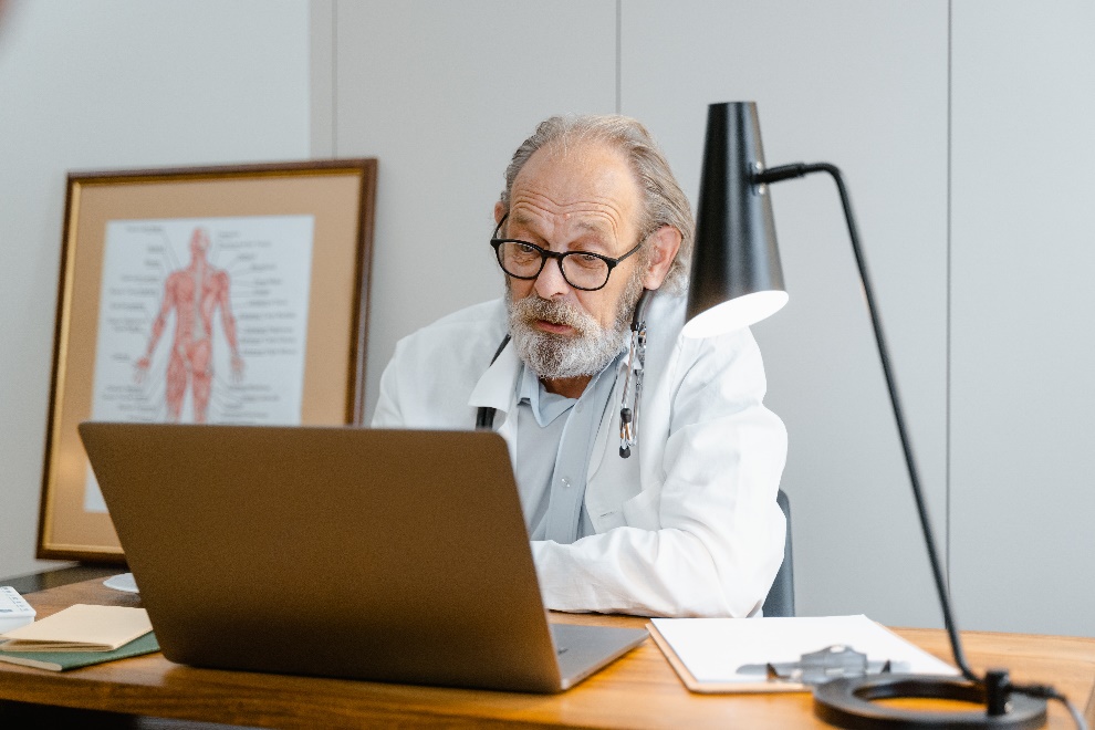 Healthcare provider reviewing information online to help patients navigate medication assistance and enrollment requirements.