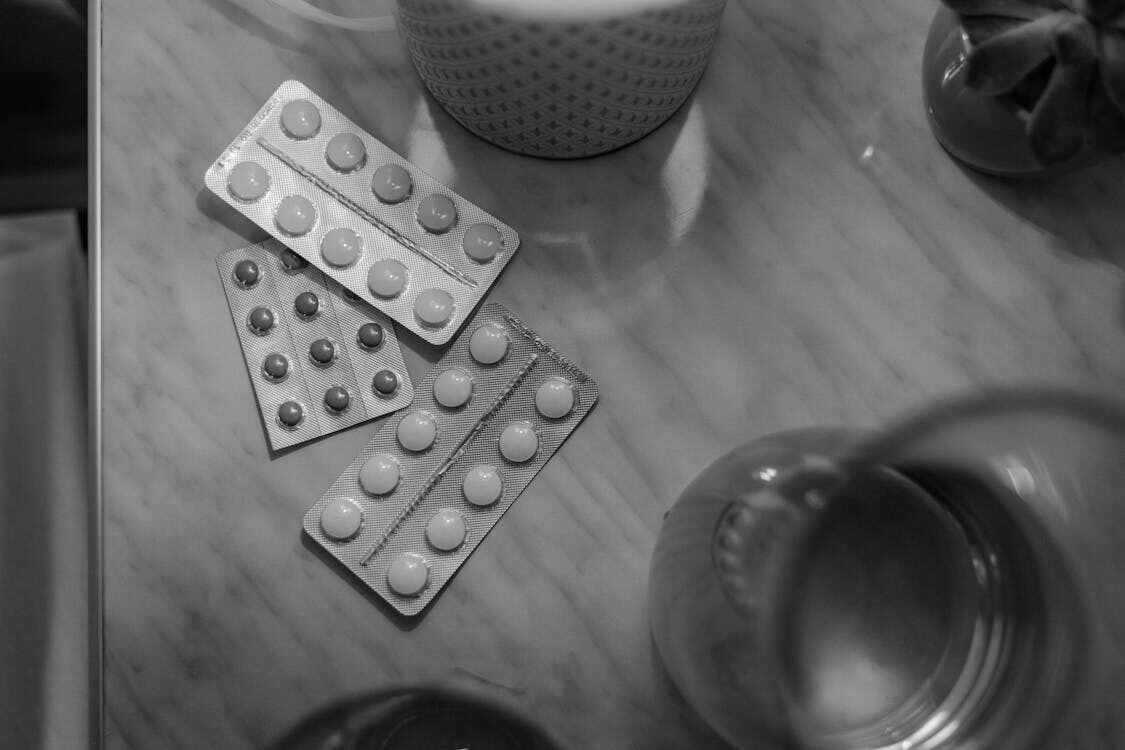 grey-scale photo of medication blister packs